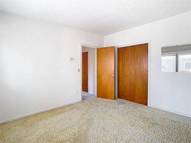 unfurnished bedroom featuring carpet flooring and a closet