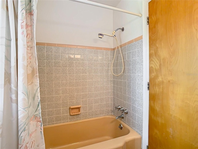 bathroom featuring shower / tub combo with curtain