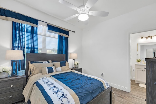 5857 Mackenzie Ave, The Villages, FL 32163 - bedroom with a ceiling fan, ensuite bathroom, baseboards, and wood finished floors