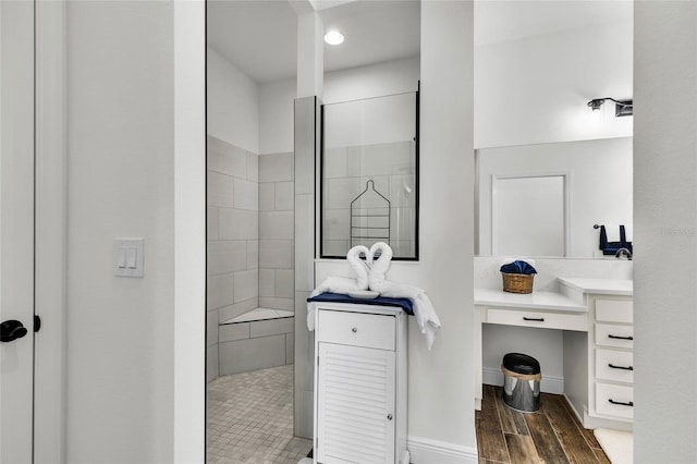 5857 Mackenzie Ave, The Villages, FL 32163 - full bath featuring wood tiled floor, baseboards, vanity, and walk in shower