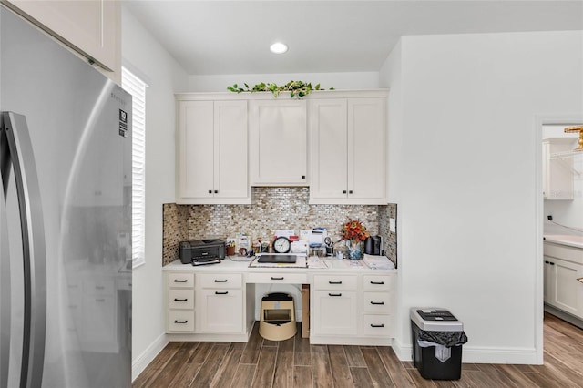 5857 Mackenzie Ave, The Villages, FL 32163 - kitchen with wood tiled floor, backsplash, and freestanding refrigerator