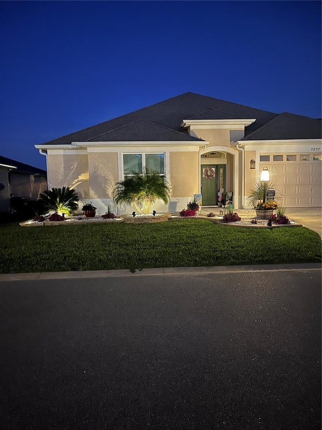 5857 Mackenzie Ave, The Villages, FL 32163 - single story home with stucco siding, a garage, and concrete driveway