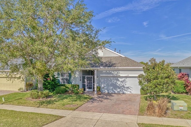 view of front of home featuring a garage and a front lawn