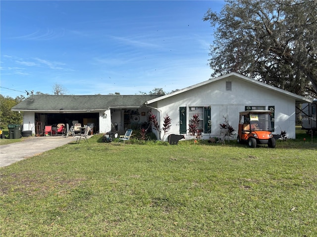 ranch-style home featuring a garage and a front lawn