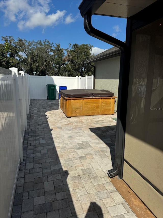 view of patio / terrace with a hot tub