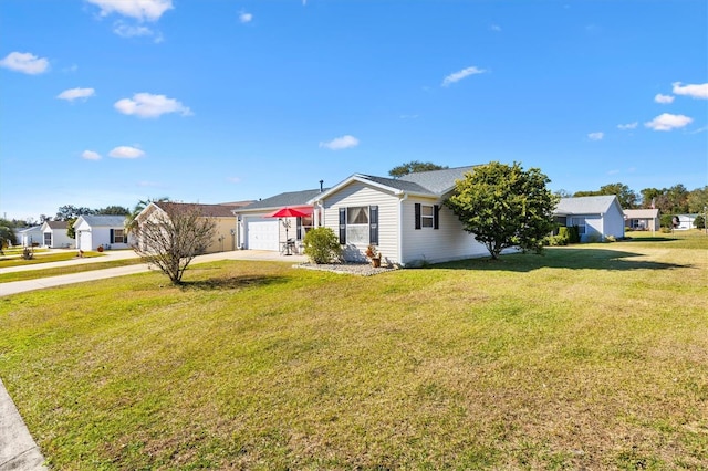 ranch-style home with a garage and a front lawn