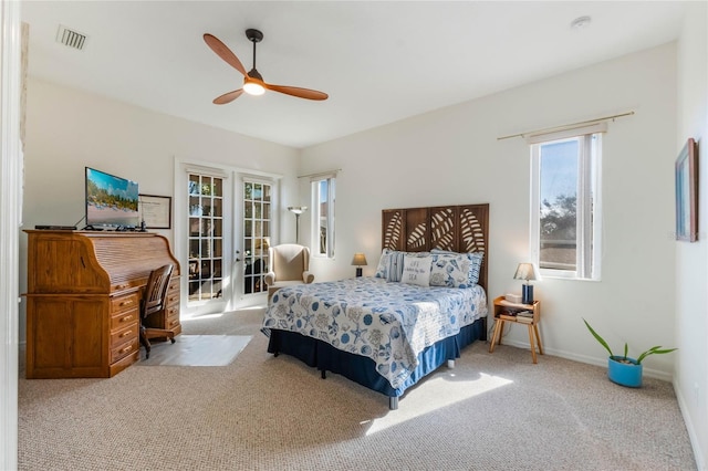 bedroom featuring light carpet, ceiling fan, french doors, and access to outside