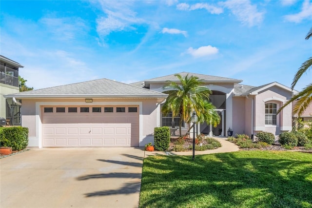 5502 Bounty Cir, Tavares, FL 32778 - single story home featuring stucco siding, driveway, a front yard, and an attached garage