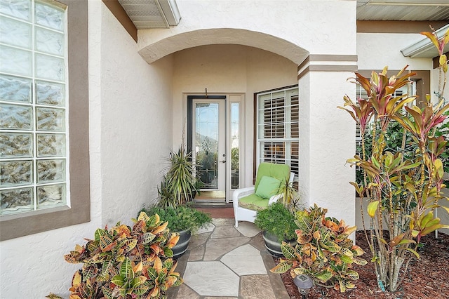 doorway to property with stucco siding