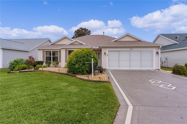 ranch-style house with a garage and a front lawn