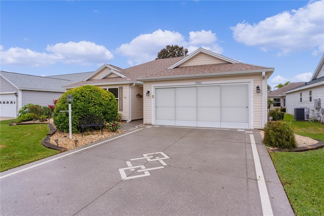 ranch-style home featuring a garage, a front yard, and central AC unit