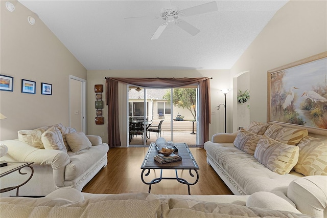 living room featuring vaulted ceiling, ceiling fan, and hardwood / wood-style flooring