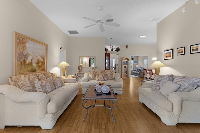 living room featuring ceiling fan and wood-type flooring