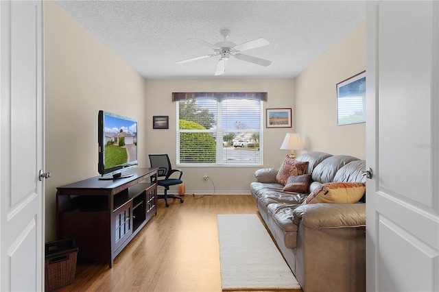 interior space featuring light wood-type flooring, ceiling fan, and a textured ceiling