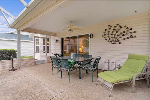 view of patio with ceiling fan and a lanai