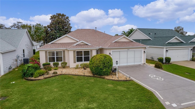 view of front of home featuring a garage, a front yard, and central air condition unit