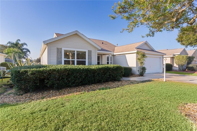 ranch-style house featuring a garage and a front lawn