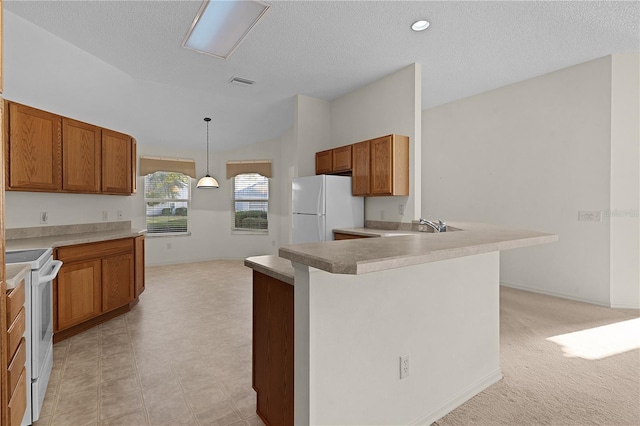 kitchen featuring lofted ceiling, sink, hanging light fixtures, white appliances, and a textured ceiling