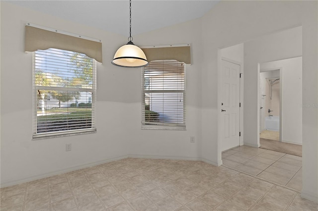 unfurnished room featuring vaulted ceiling