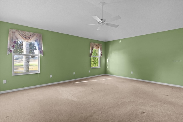 unfurnished room featuring a textured ceiling, vaulted ceiling, ceiling fan, and carpet