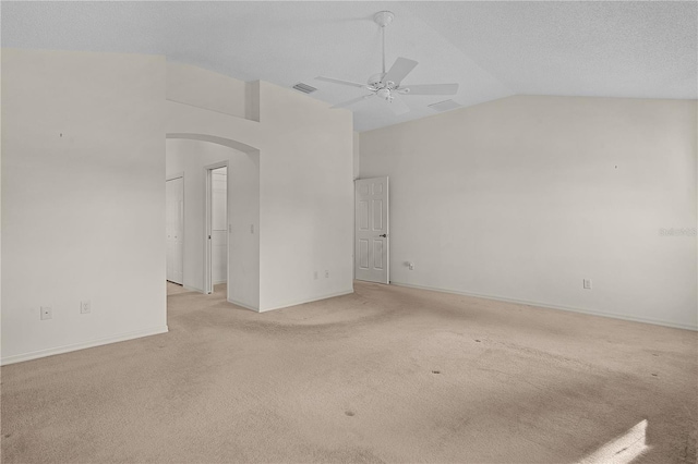 spare room featuring ceiling fan, light colored carpet, high vaulted ceiling, and a textured ceiling