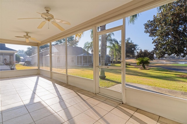 unfurnished sunroom featuring ceiling fan