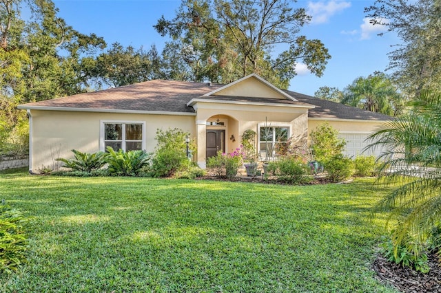 single story home featuring a front lawn and a garage