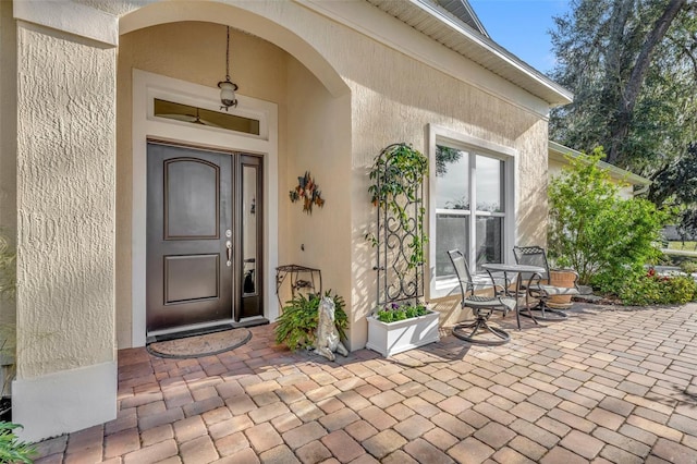 property entrance featuring a patio