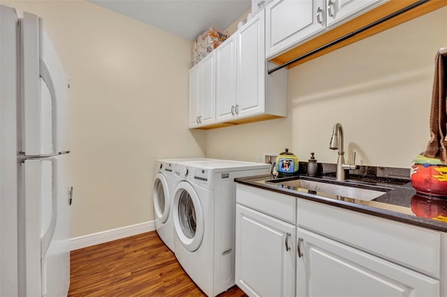 washroom featuring separate washer and dryer, sink, and light hardwood / wood-style flooring