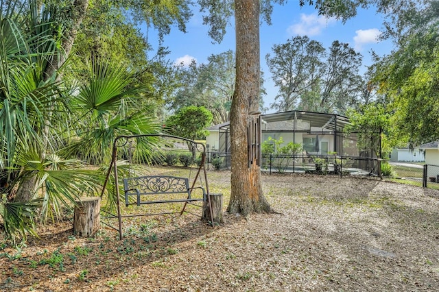 view of yard featuring glass enclosure