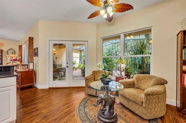 sitting room with ceiling fan, dark hardwood / wood-style flooring, and french doors