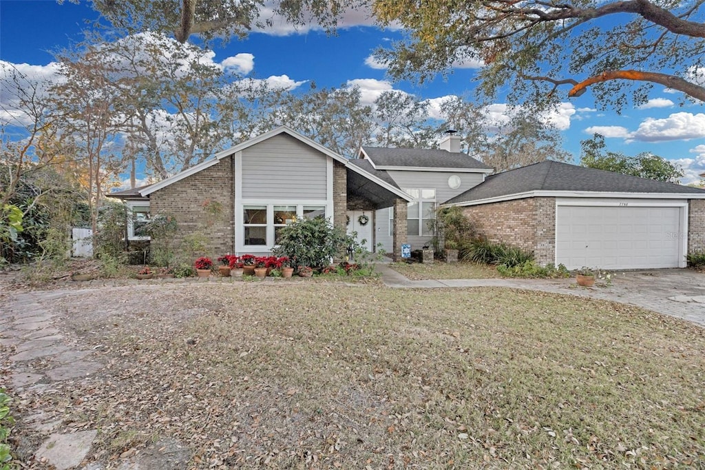 ranch-style home featuring a garage and a front yard