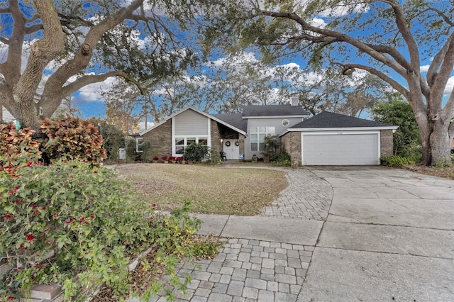 ranch-style home featuring a garage and a front yard