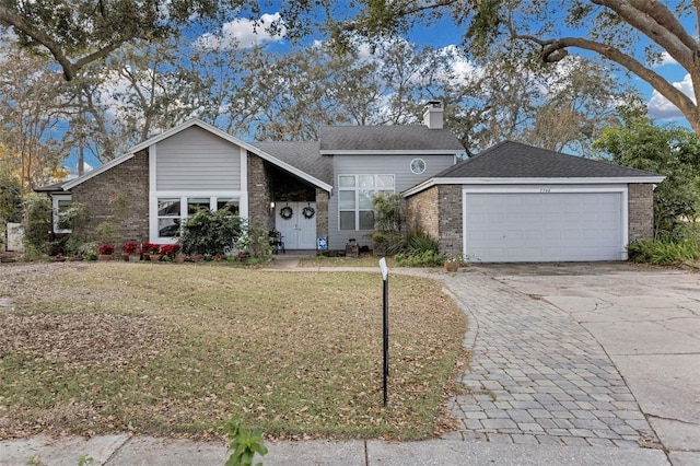 ranch-style house featuring a garage and a front lawn