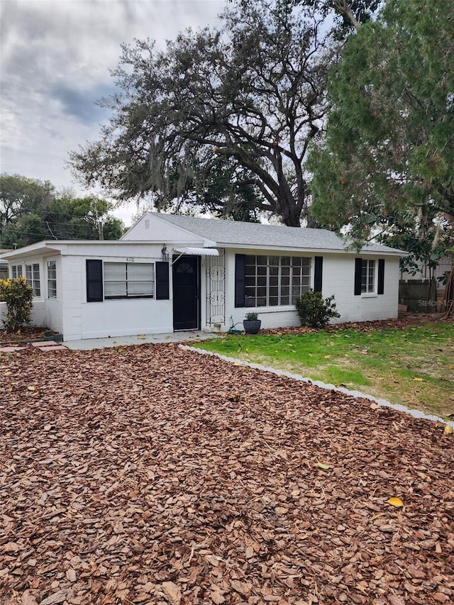 ranch-style home with a front lawn