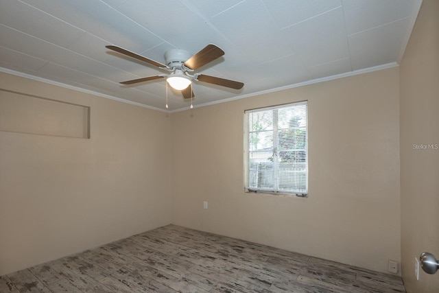 empty room featuring ceiling fan, wood-type flooring, and ornamental molding