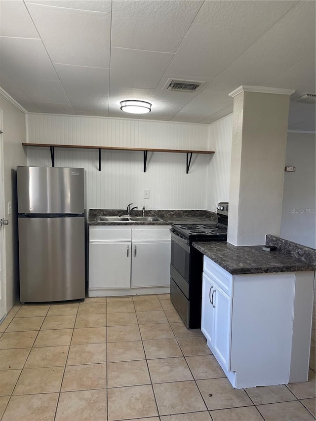 kitchen with white cabinetry, sink, stainless steel fridge, range with electric cooktop, and light tile patterned floors