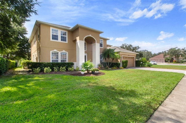 mediterranean / spanish-style home featuring a front yard and a garage