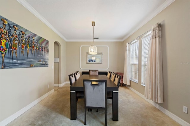 carpeted dining space featuring crown molding