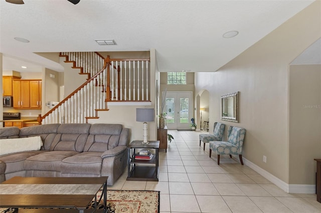 living room featuring light tile patterned floors and french doors