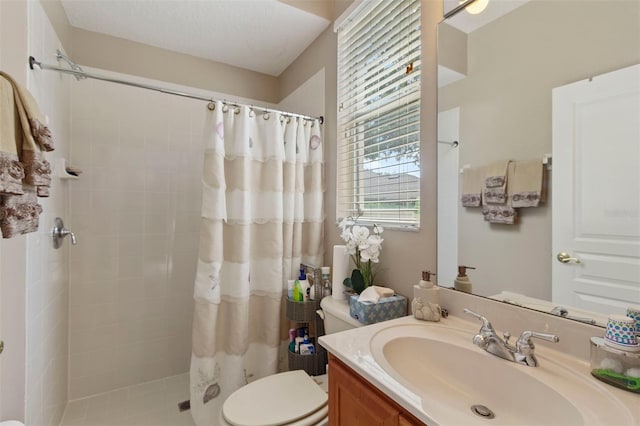 bathroom featuring toilet, vanity, and curtained shower