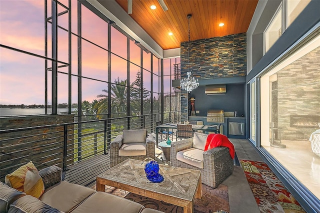 patio terrace at dusk with area for grilling, a balcony, and an outdoor hangout area