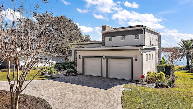 view of front of home with a garage and a front yard