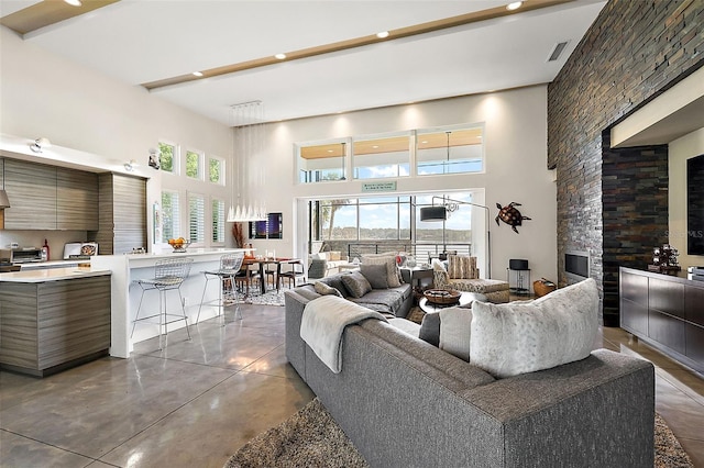 living room with concrete flooring and a high ceiling