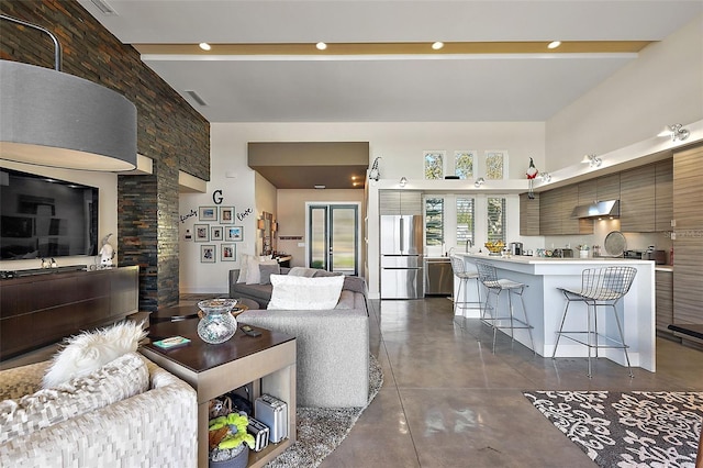 living room featuring a high ceiling, beam ceiling, and french doors