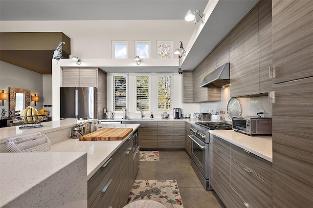 kitchen featuring light stone counters, appliances with stainless steel finishes, and ventilation hood