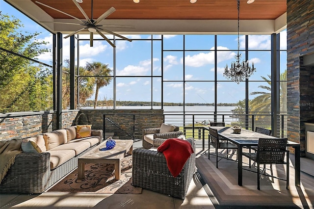 sunroom / solarium with wooden ceiling, a water view, and a healthy amount of sunlight