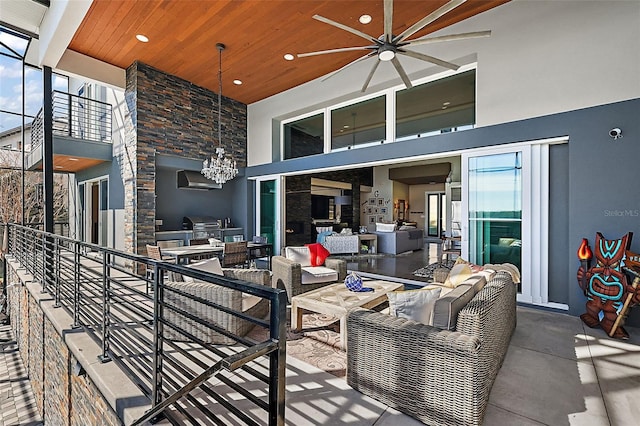 view of patio with ceiling fan, area for grilling, and an outdoor living space