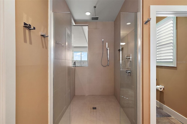 bathroom featuring tile patterned floors and tiled shower