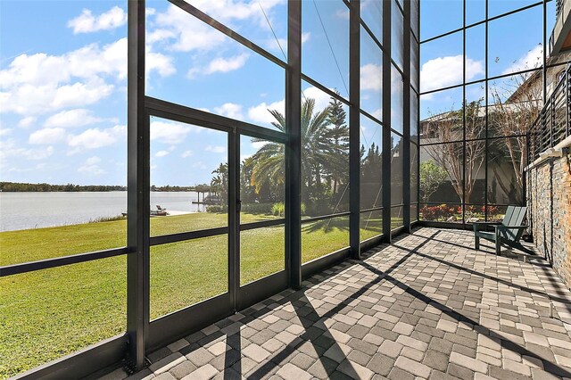 unfurnished sunroom with a water view